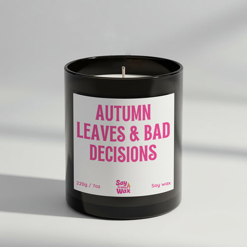 Autumn Leaves & Bad Decisions soy wax candle in matte black glass jar with seasonal label and ash wooden lid, scented with spicy Sahara fragrance
