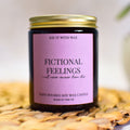 Fictional Feelings Candle with a pink label on a woven surface