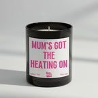Mum’s Got the Heating On soy wax candle in matte black glass jar with seasonal label and ash wooden lid, scented with cosy Fireside fragrance