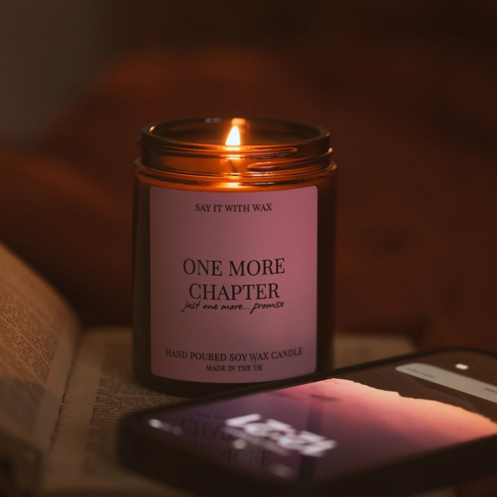 Close-up of the One More Chapter candle label reading “just one more... promise”, on an amber jar with hand poured soy wax candle, made in the UK