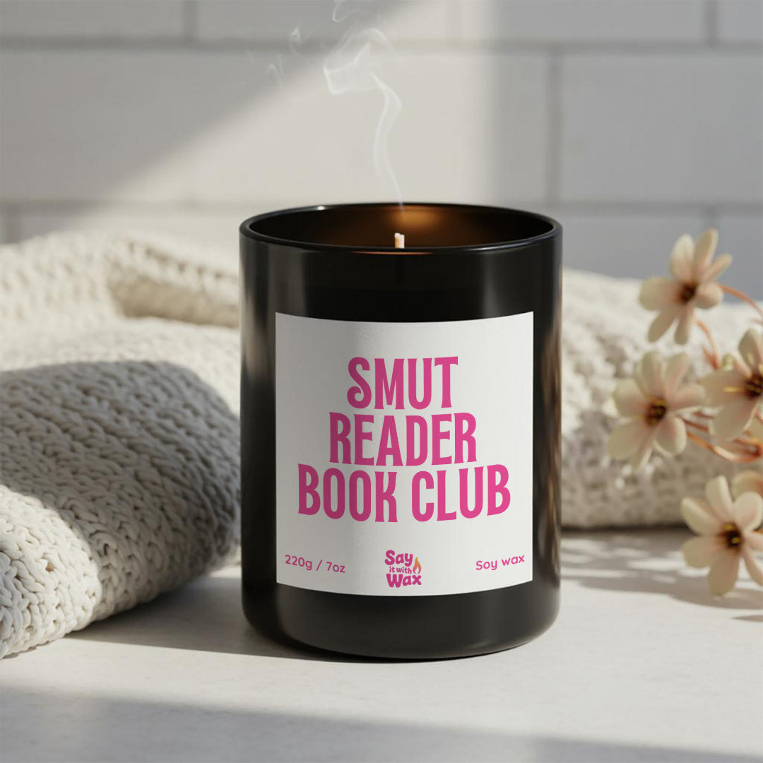 Smut Reader Book Club soy wax candle in matte black glass jar with pink label and ash wooden lid, funny romance reader and book club gift
