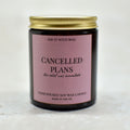 Candle with a pink label with the text cancelled plans, the relief was immediate on a white background