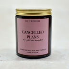 Candle with a pink label with the text cancelled plans, the relief was immediate on a white background